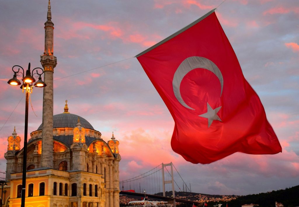 The Turkish flag Ortaköy Mosque in Istanbul at golden hour